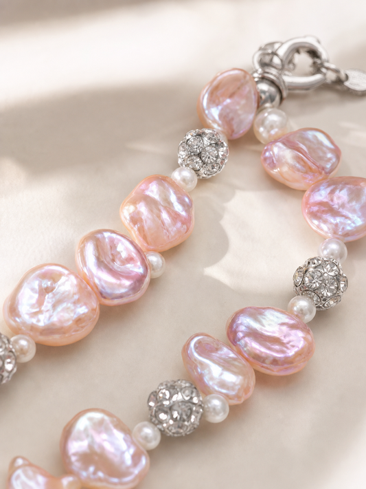 Close-up of pink freshwater baroque pearl necklace with mirror-like luster and silver accents