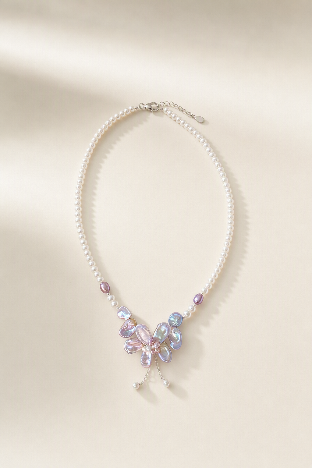 3-12mm Freshwater Pearl necklace on a cream white background