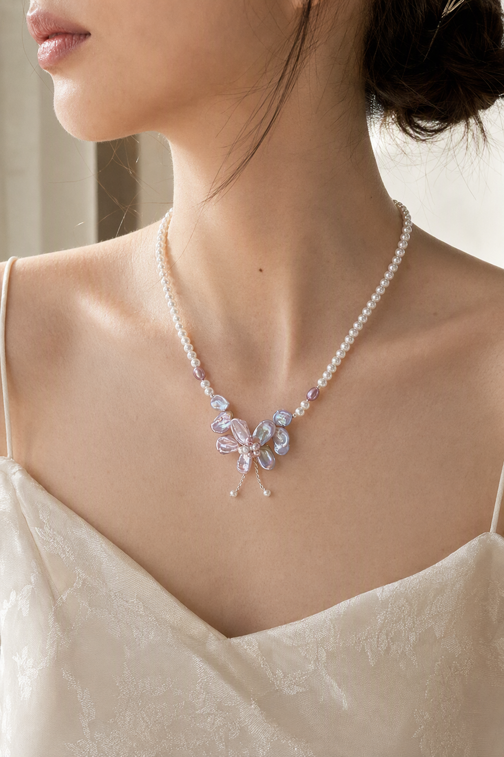Model wearing 3-12mm Freshwater Pearl necklace naturally at the neckline