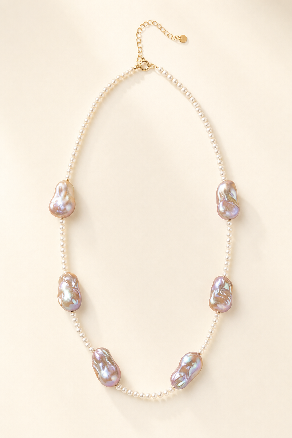 Soft Glow High Luster 4-4.5mm small pearls; 20mm+ medium baroque pearls Freshwater Pearl necklace on a cream white background