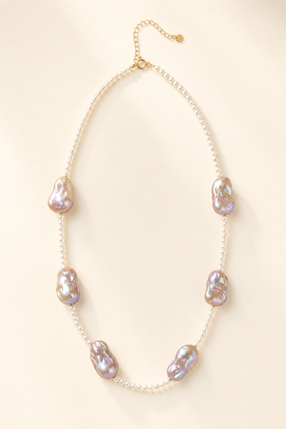 Soft Glow High Luster 4-4.5mm small pearls; 20mm+ medium baroque pearls Freshwater Pearl necklace on a cream white background