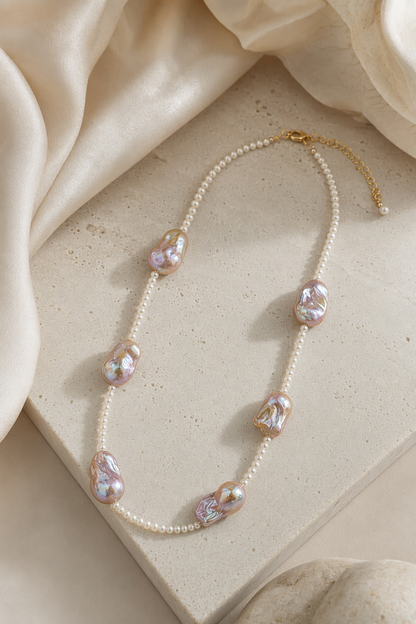 Soft Glow High Luster 4-4.5mm small pearls; 20mm+ medium baroque pearls Freshwater Pearl necklace in an elegant still-life luxury setting