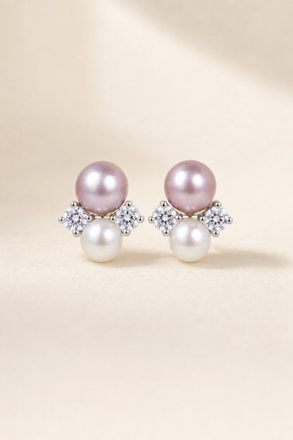 Mirror Luster 9–10 mm purple pearl with 6–7 mm white pearl Freshwater Pearl stud earrings on a cream white background