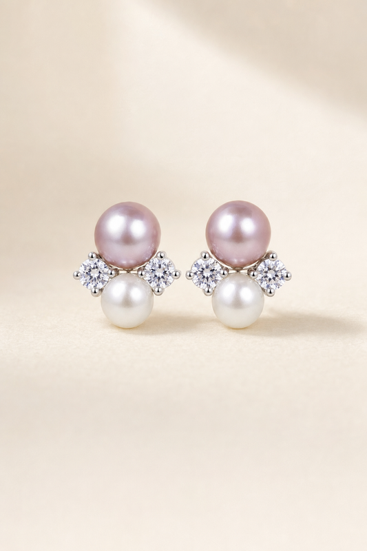 Mirror Luster 9–10 mm purple pearl with 6–7 mm white pearl Freshwater Pearl stud earrings on a cream white background