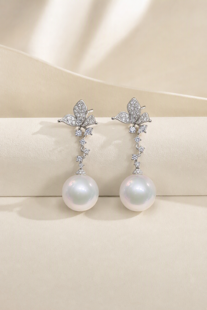 Venus Luster 11-12mm Australian South Sea Pearl stud earrings on a cream white background