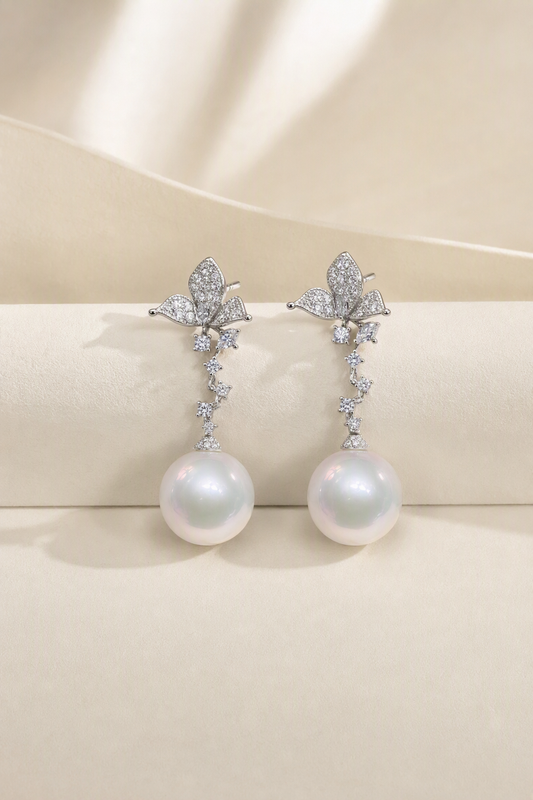 Venus Luster 11-12mm Australian South Sea Pearl stud earrings on a cream white background