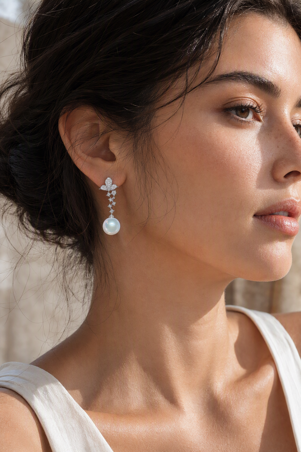 Model wearing Venus Luster 11-12mm Australian South Sea Pearl stud earrings naturally on the earlobe