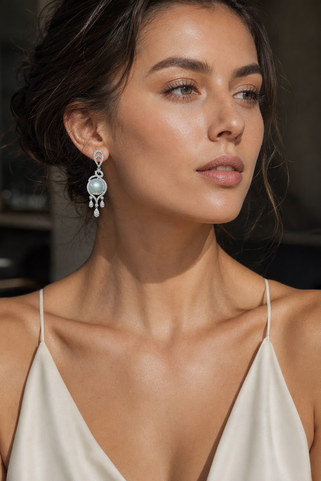 Model wearing Venus Luster 11-12mm Australian South Sea Pearl stud earrings naturally on the earlobe