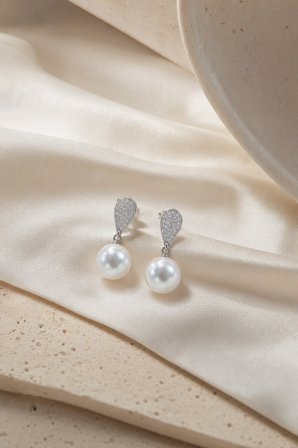 Venus Luster 11-12mm Australian South Sea Pearl Stud Earrings in a still-life ivory silk luxury environment