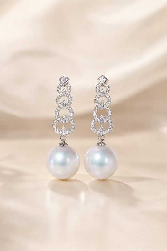 Venus Luster 12-13mm Australian South Sea Pearl Stud Earrings on a cream white primary background