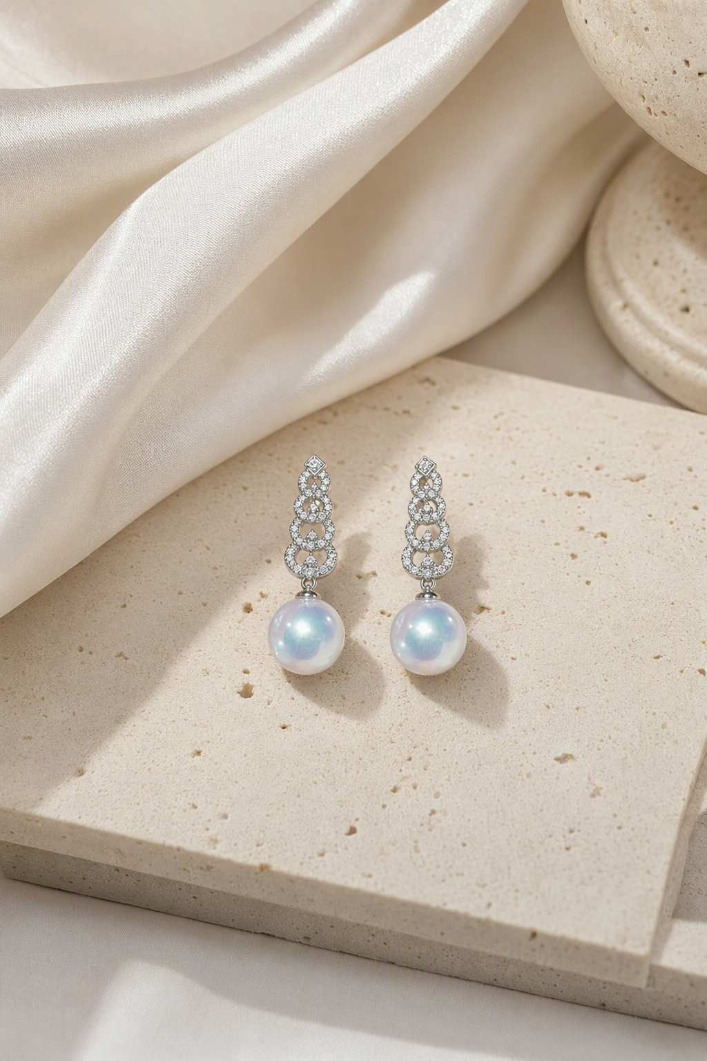 Venus Luster 12-13mm Australian South Sea Pearl Stud Earrings in a still-life ivory silk luxury environment
