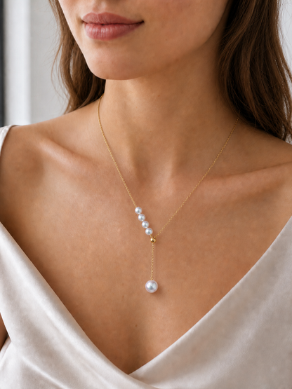 Akoya pearl necklace on model showing white mirror-luster pearls and delicate gold chain
