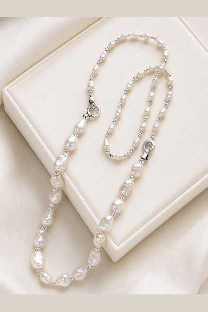 White freshwater baroque pearl necklace with mirror-like luster on a luxury display surface