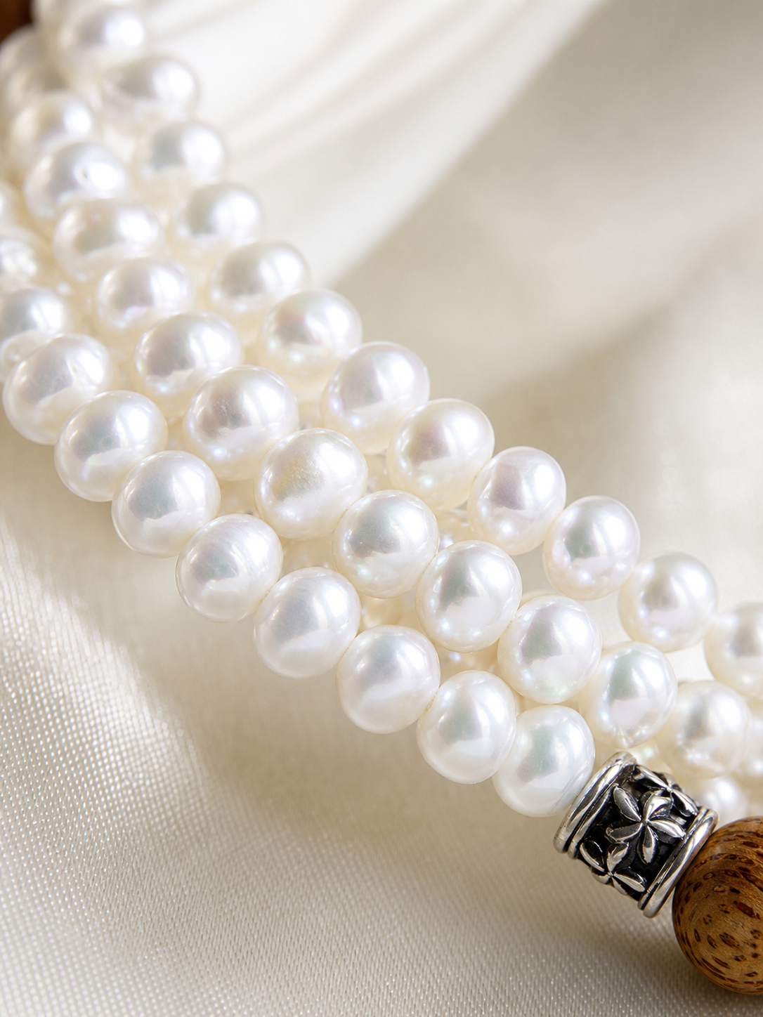Macro detail of 2-3mm round aurora freshwater pearls showing mirror-like nacre luster