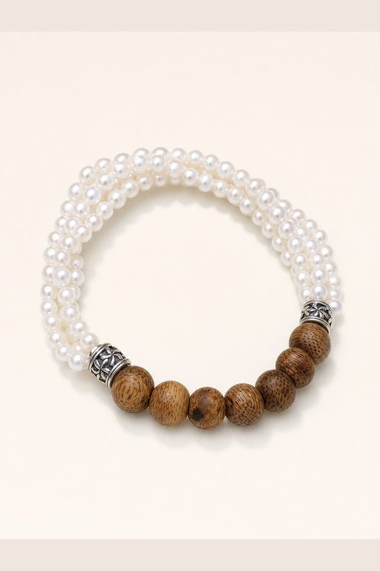 White round freshwater pearl agarwood bracelet with mirror-like luster on ivory background