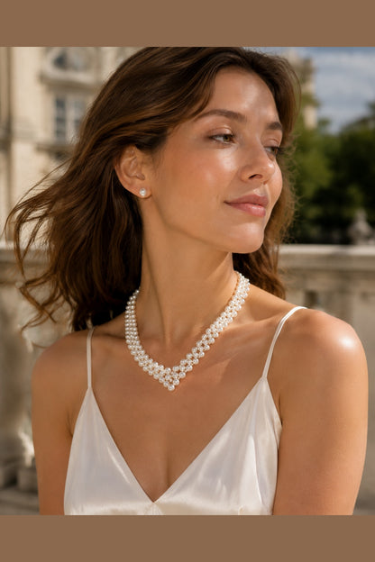 woman wearing a woven freshwater pearl necklace with layered pearl strands